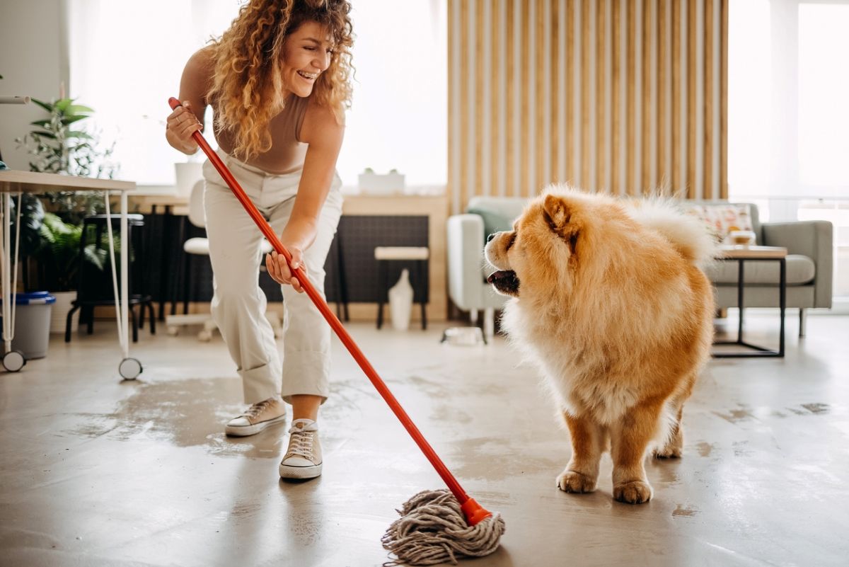 Pet owner cleaning a home shared with her dog